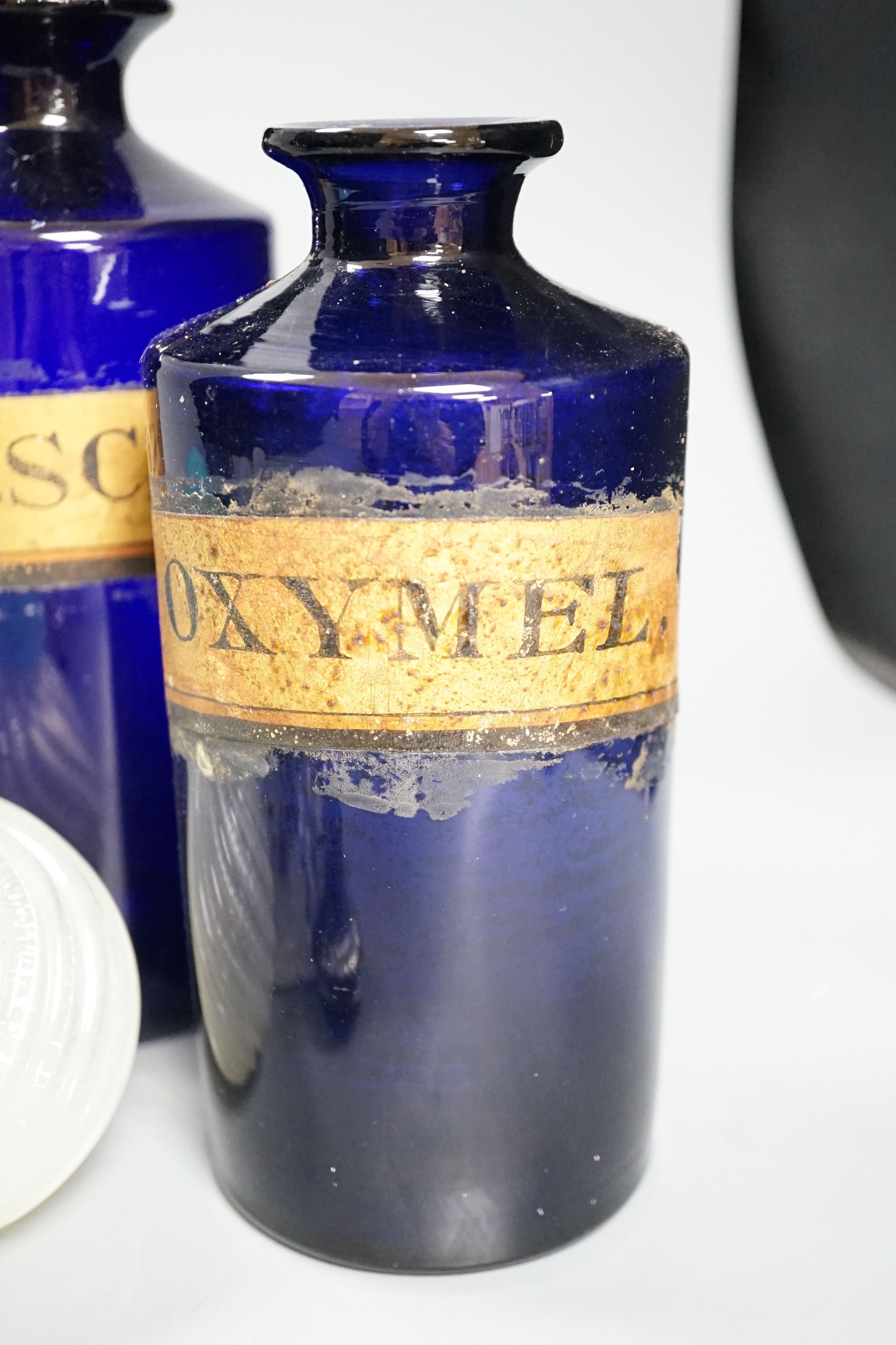A pair of blue glass drug jars and a novelty glass dog inkwell etc, tallest 24 cms high